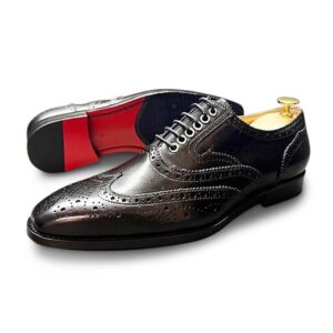 Black longwing derby with a red sole